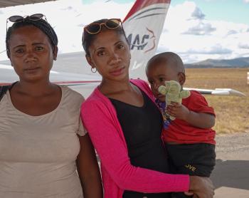 Lovasoa with his mom and his aunt holding him