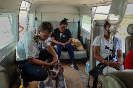 Pilot Patrick Keller praying for Tahiana before the flight